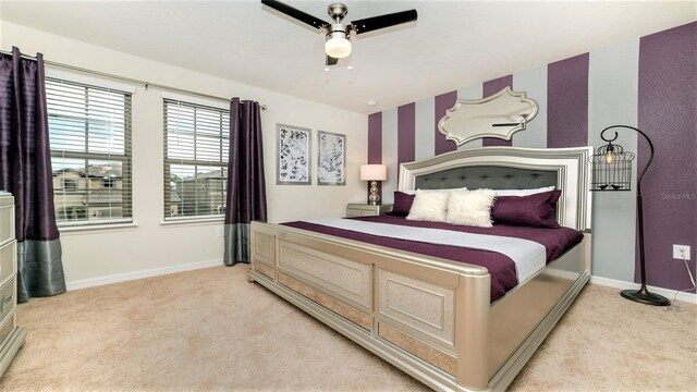 bedroom with ceiling fan and light carpet