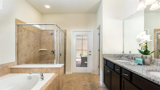 bathroom featuring tile patterned flooring, vanity, and plus walk in shower