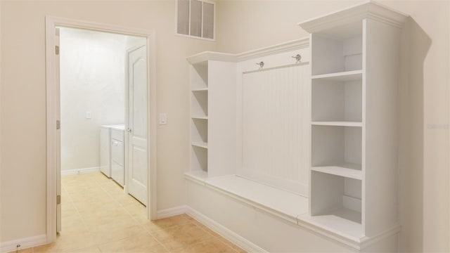 mudroom featuring washer and dryer and light tile patterned floors