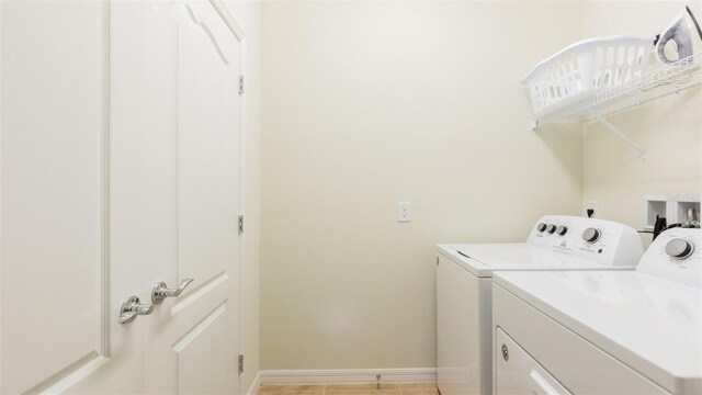 washroom with independent washer and dryer and light tile patterned floors