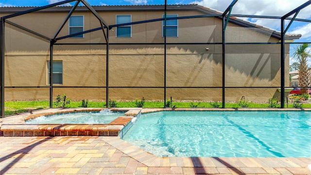 view of swimming pool with an in ground hot tub, pool water feature, and a lanai