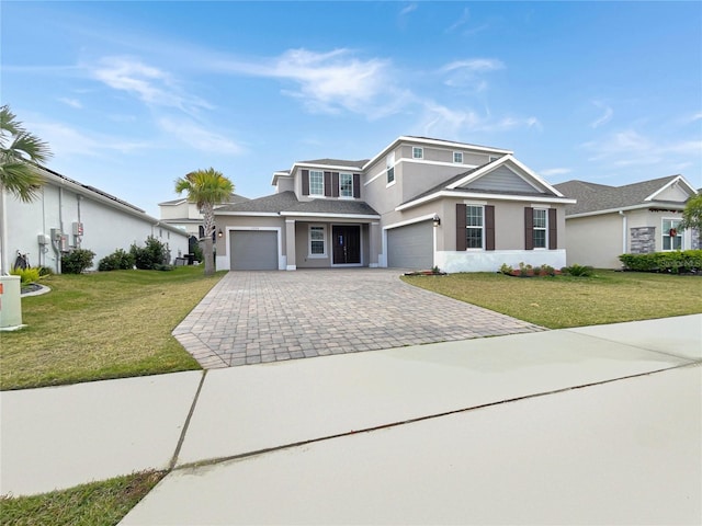 view of front of house featuring a garage and a front lawn