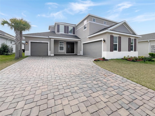 view of front property featuring a front yard and a garage