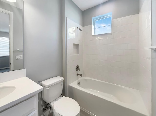 full bathroom with toilet, vanity, and tiled shower / bath