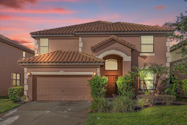 mediterranean / spanish-style house with a garage