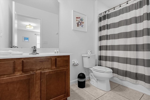 bathroom featuring tile flooring, large vanity, and toilet