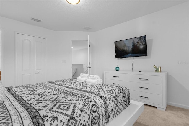 carpeted bedroom featuring a closet