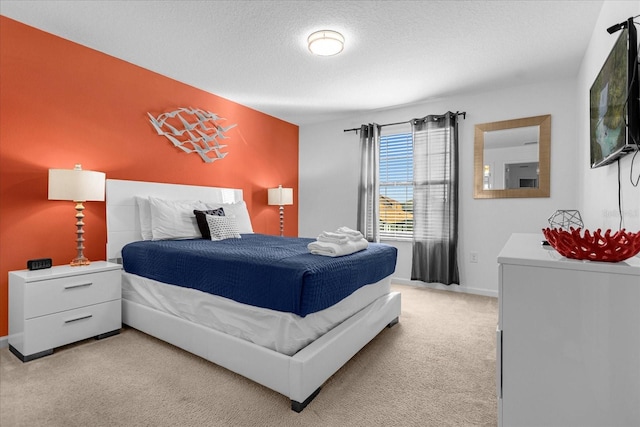 carpeted bedroom featuring a textured ceiling