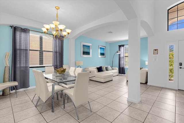 tiled dining space with an inviting chandelier