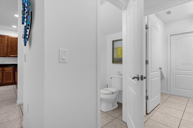 bathroom with toilet and tile flooring