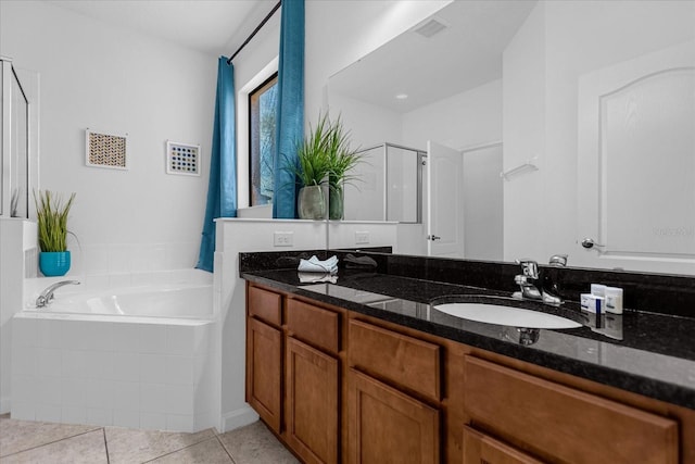 bathroom with double sink vanity, separate shower and tub, and tile floors