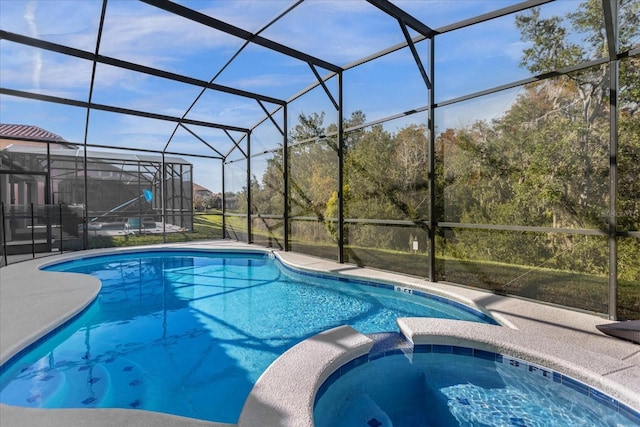 view of pool featuring an in ground hot tub and a lanai