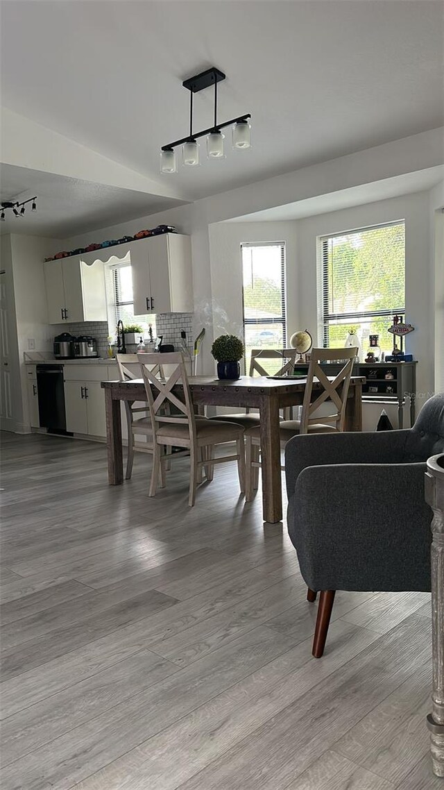 dining area featuring track lighting and light wood-type flooring