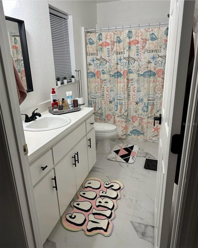 bathroom with vanity, tile patterned flooring, and toilet