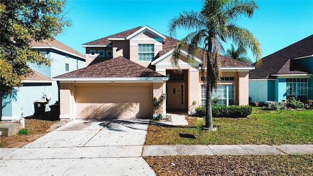 view of front of home featuring a garage and a front lawn