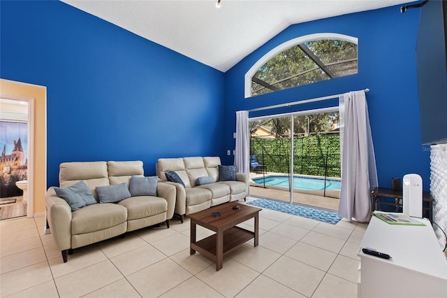 living room featuring high vaulted ceiling and light tile patterned floors