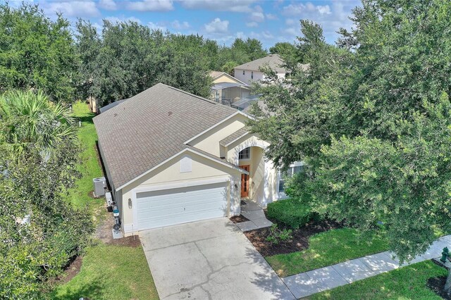 view of front of home with a garage and a front lawn