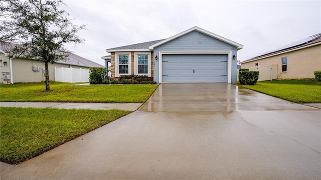 single story home with a garage, driveway, a front lawn, and fence