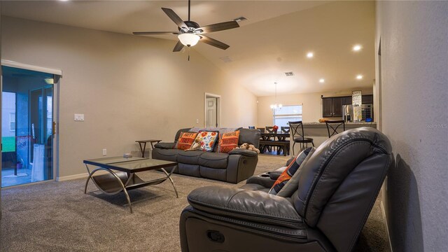 living room with baseboards, visible vents, light colored carpet, vaulted ceiling, and ceiling fan with notable chandelier