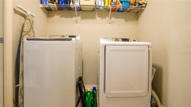 clothes washing area featuring laundry area and separate washer and dryer