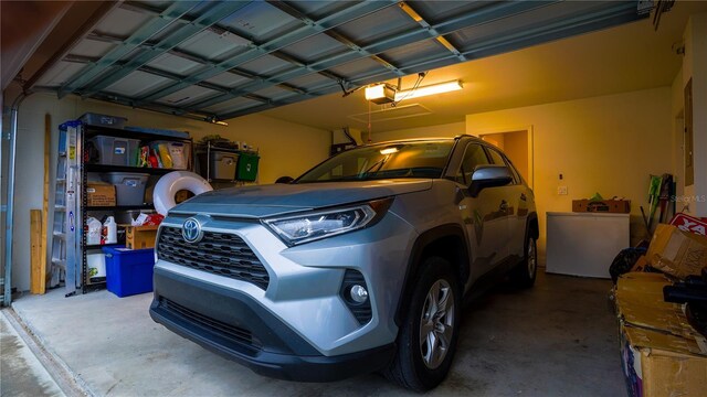 garage with fridge and a garage door opener