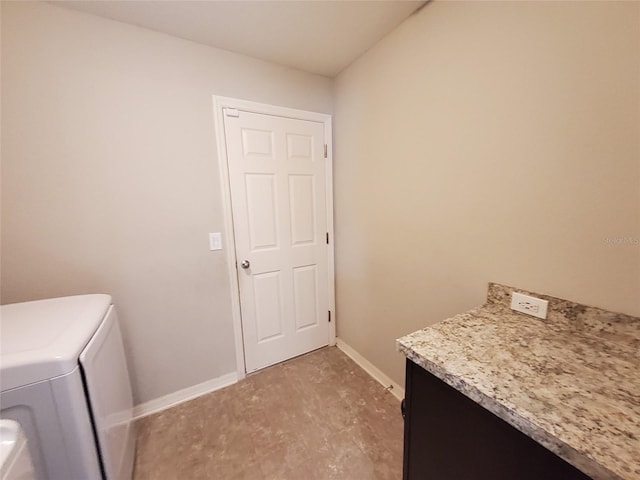 clothes washing area with laundry area, washer and clothes dryer, and baseboards