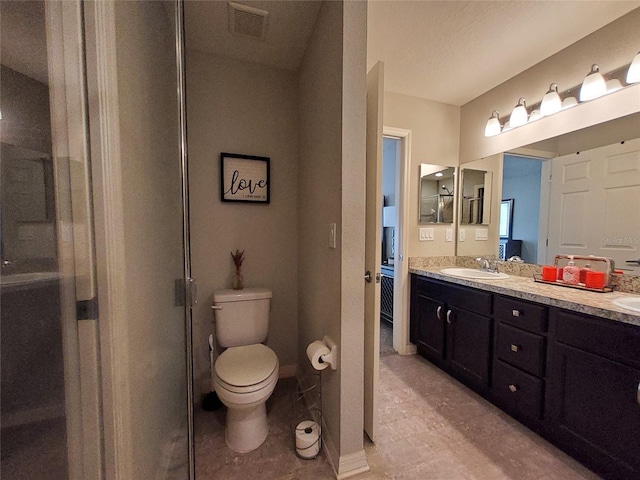 bathroom with double vanity, visible vents, toilet, a stall shower, and a sink