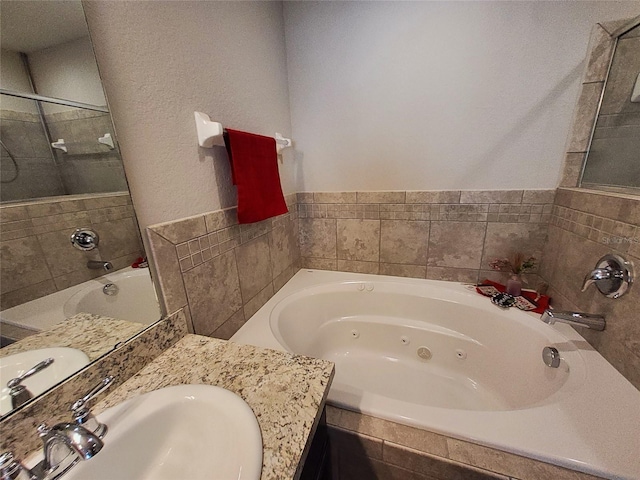 bathroom featuring a jetted tub and vanity