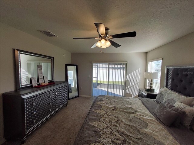 bedroom with a textured ceiling, visible vents, a ceiling fan, access to outside, and carpet