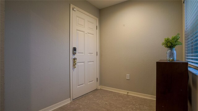 interior space with concrete flooring and baseboards