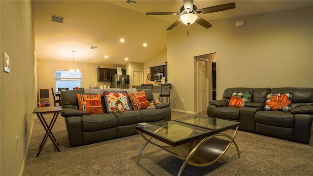 carpeted living area featuring recessed lighting, visible vents, high vaulted ceiling, and ceiling fan with notable chandelier