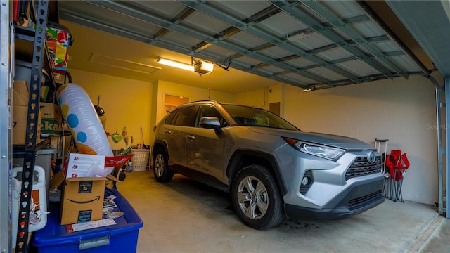 garage with a garage door opener and concrete block wall