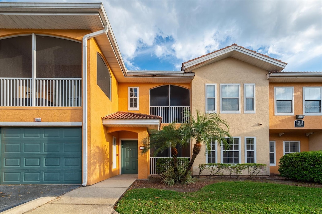 view of front of home with a balcony and a garage