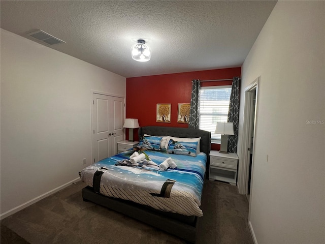 carpeted bedroom featuring a textured ceiling