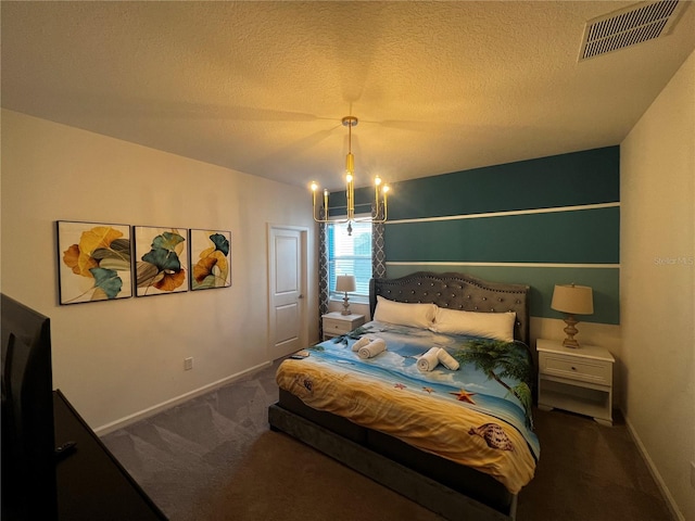 carpeted bedroom featuring a textured ceiling and an inviting chandelier