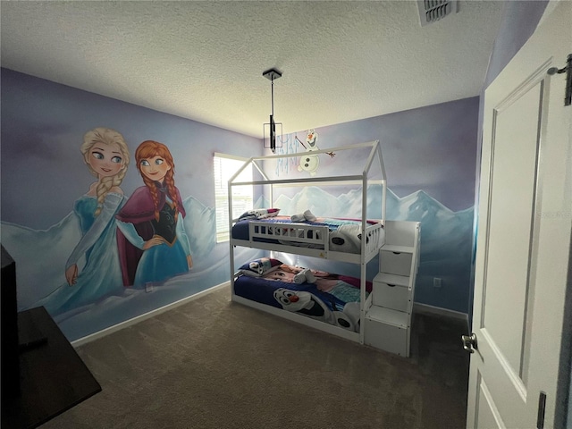 bedroom featuring a textured ceiling and carpet flooring