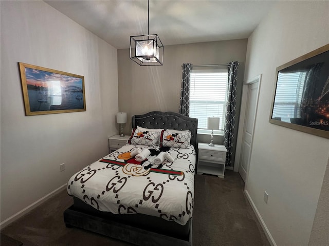 carpeted bedroom featuring a notable chandelier