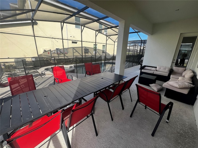 view of patio with glass enclosure and outdoor lounge area