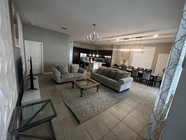 tiled living room with an inviting chandelier