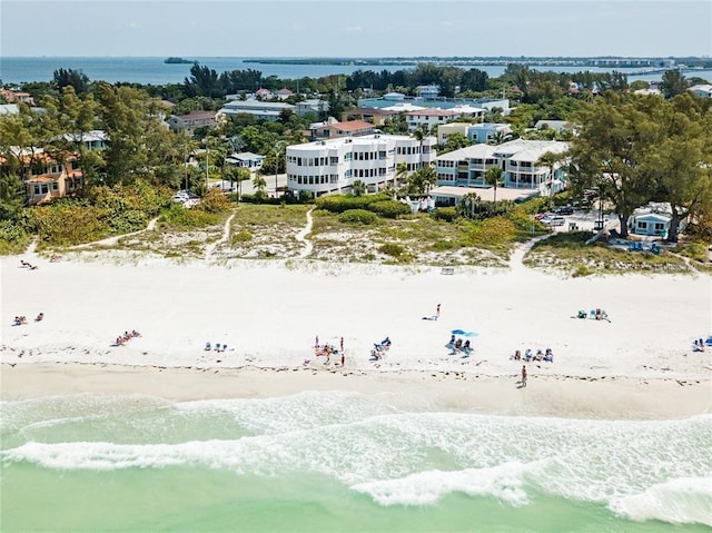 bird's eye view with a water view and a beach view