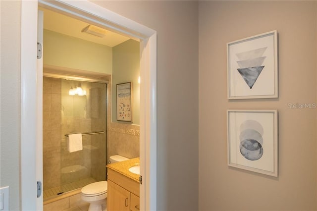 bathroom with an enclosed shower, vanity, and toilet