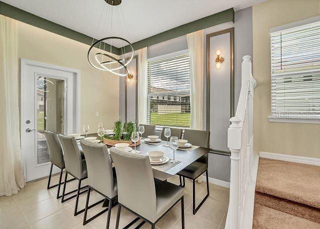 dining area with a chandelier and light tile patterned floors