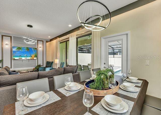 dining area with a chandelier and a textured ceiling