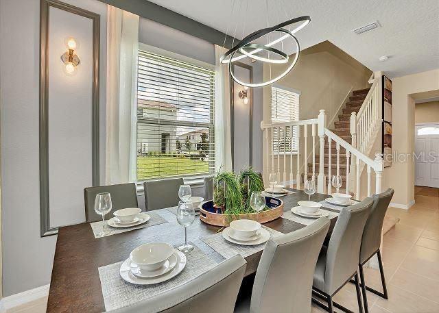 dining room with plenty of natural light, a notable chandelier, and a textured ceiling