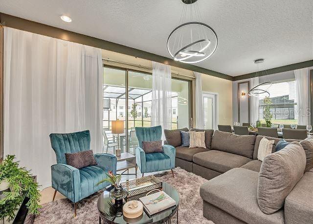 living room featuring a notable chandelier and a textured ceiling