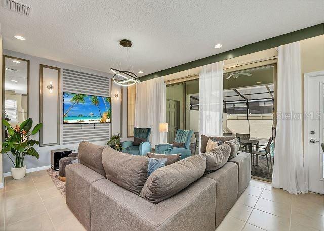 living room featuring a textured ceiling and light tile patterned flooring