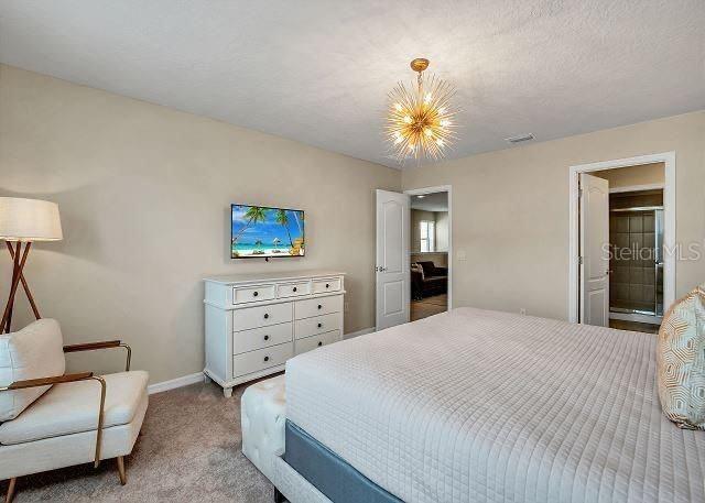 carpeted bedroom with a textured ceiling