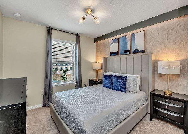 carpeted bedroom with a textured ceiling