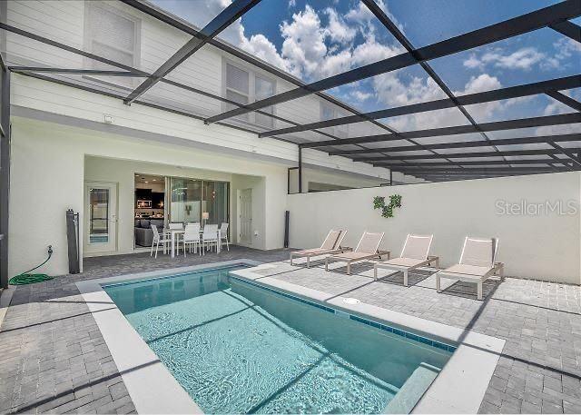 view of pool with a lanai and a patio area