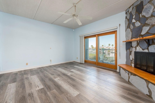 interior space with hardwood / wood-style flooring, a fireplace, and ceiling fan